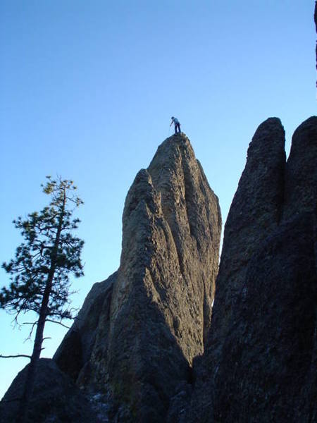 This is taken after walking through the notch to the right of the tunnel. The climb starts on the lower left of the picture to the right of the tree you see. This is a picture of the Moonlight Rib with a climber on top getting ready to rappel.