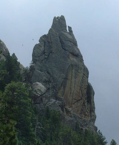 Dire Spire from the highway.  Snakebite Evangelist climbs the obvious steep crack, the Engagement climbs the dark face to the right, and the Conn route starts on the back side.