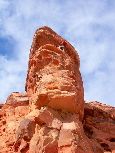 Karsten tops out on the only small holds on the route