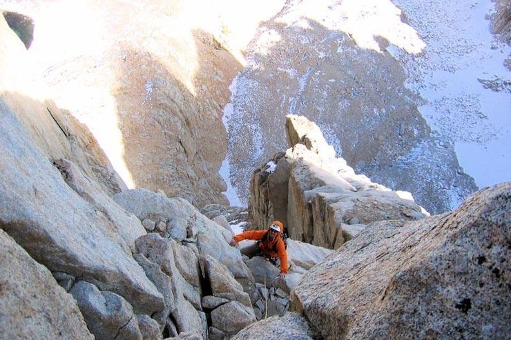 Tom Slater topping out above the "washboard", leaving the snow behind but going into the cold shadows.<br>
Photo Doug Englekirk.