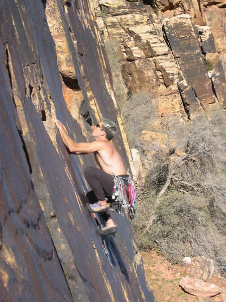 Tiptoeing up to the last jug before the crux. Photo by Michelle Moffat, 2004