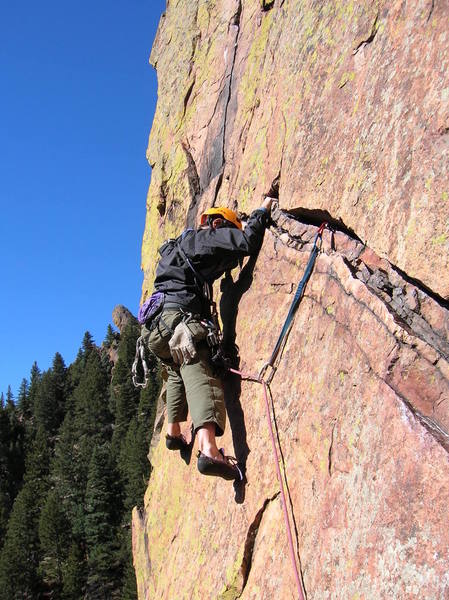 Gary tip toeing across the traverse on 4th pitch.