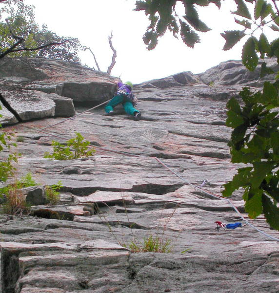 Jean Aschenbrenner climbing the huge flakes near the top of the first pitch.