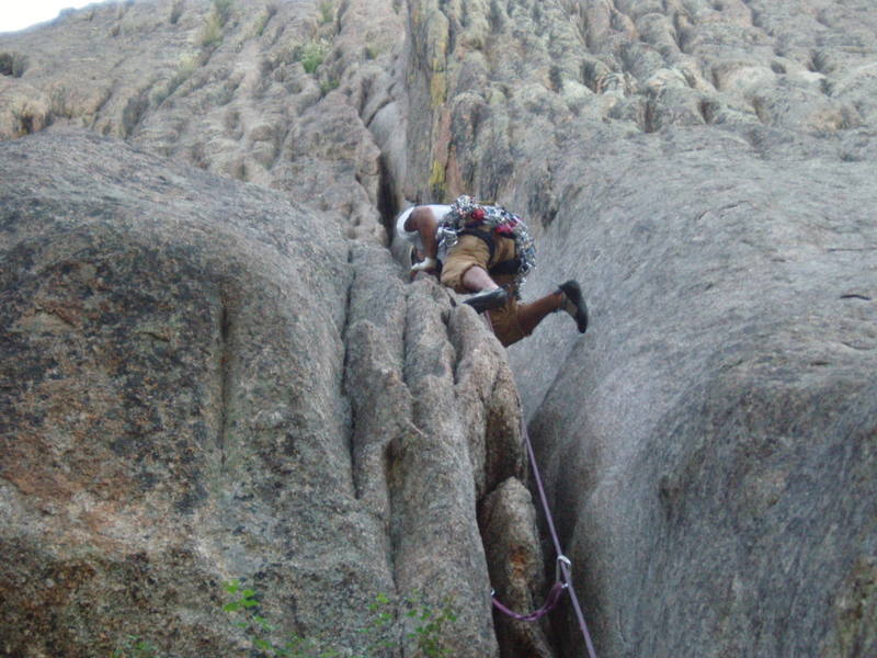 Ahad Sabet pulling through the awkward section of the 1st pitch on Osiris, Lumpy Ridge, CO.