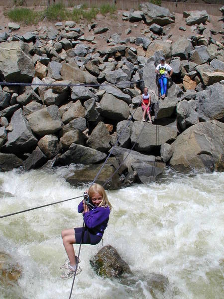 The tyrolean traverse across Boulder Creek. Gaelyn Crowder, age 7, putting a brave face on it.