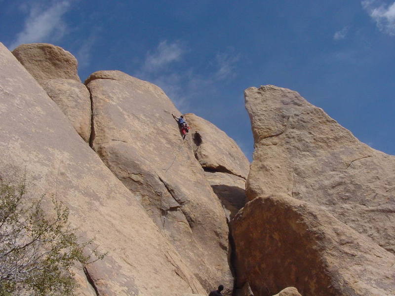 Deciphering the moves for the second crux on the rounded arete.