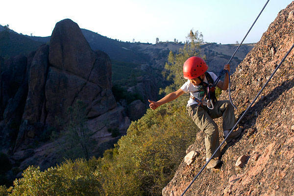 Nine-year-old Billy Louie triumphantly signals his belayer on the First Sister.