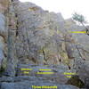 Three Dihedrals.  All climbs start at the base of a low-angle ramp.  <br>
<br>
Dihedral One takes the steep corner on the left. (5.7)<br>
<br>
Common Denominator climbs the arete and face right of Dihedral One. (5.9+)<br>
<br>
Dihedral Two climbs the bushy corner right of Common Denominator. (5.8)<br>
<br>
Dominatrix is the third dihedral; it starts uphill on the right. (5.8 or 5.10)