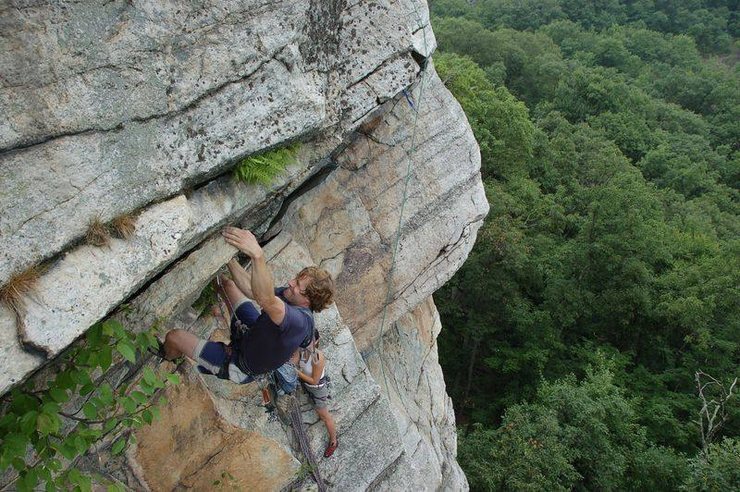 Gaining the point. The crux sloper is the faintly orange-colored angled thing in the upper left corner of the photo.