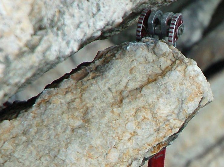 A tight shot of the cam while he was hanging on it. I've seen shakier placements, but never a shakier placement that actually held a fall. After lowering and traversing back to the belay, Jeff gave the rope a flick and the cam popped out and slid down the rope into his hand. No cleaning necessary. Very efficient of him.