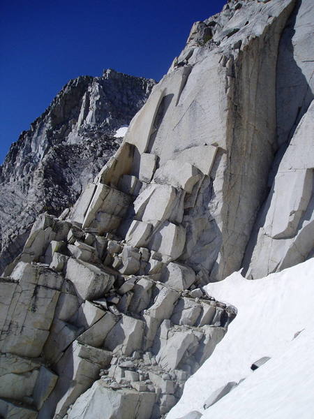 Looking across the gully to the ledges that mark the normal start of the route, which is just below the large detached flake on the left ridge line.