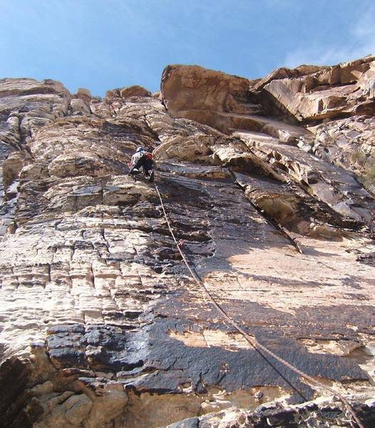 Face-climbing on the first pitch of Sunburn. The route works up to the left side of the huge roof above.
