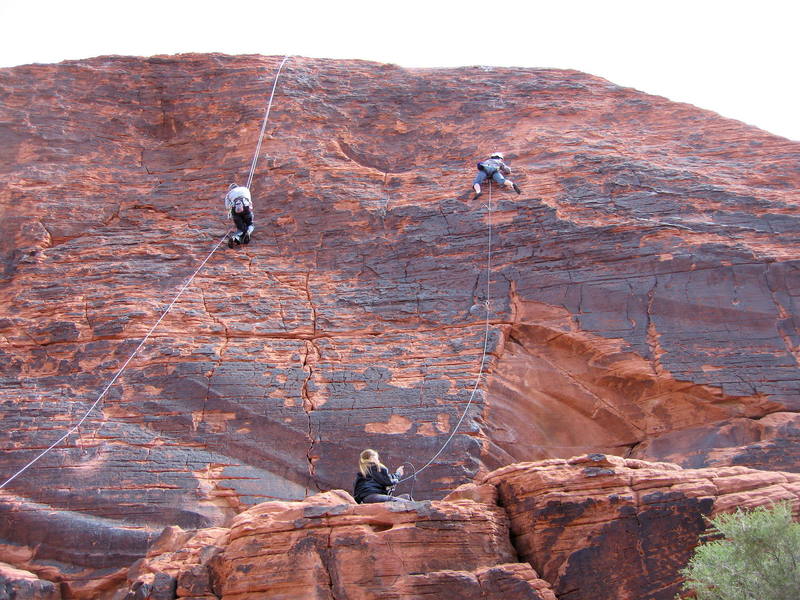 Climbers on Neon Sunset (left) and Technicolor Sunrise (right). Zipperhead starts on the thin crack between these routes.