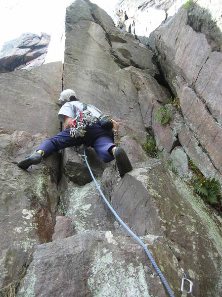 Jerry Wingenter leads Grand Illusion via the 5.10b variation start. This is a great route and a great start to it.<br>
Takes gear very well as you can sort of see in this photo (nice splitter coming out of his head). Take a few Ball Nuts with you. You can just see the crux section of the upper part of Grand Illusion in the upper left of photo.
