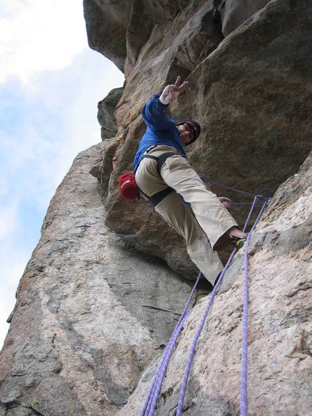 Rob Kepley at the 2nd belay end of pitch 3 on the slab. The pitch 4 .10a crux is visible near his left hip.