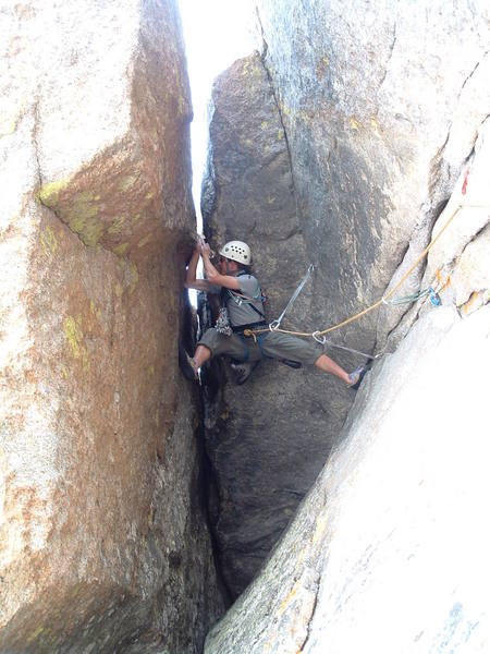 Twisting around at the crux.