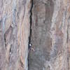 An unknown climber stemming up Superior Crack.
