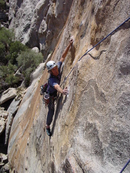 Ivan starting the crux traverse to the P1 anchors. Hands and feet get thinner as you move across.