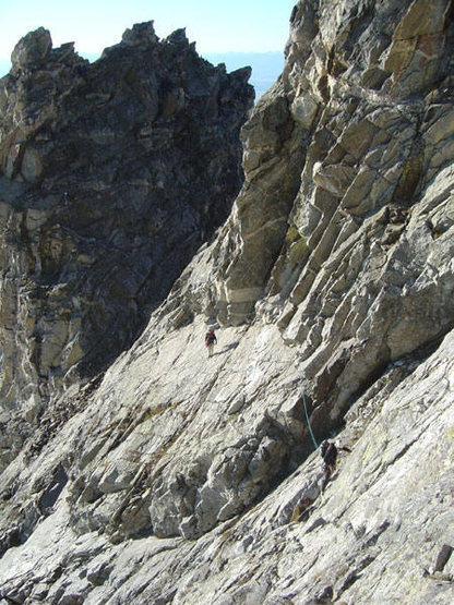 Traversing below Unsoeld's Needle. During the ascent we simul-climbed it but during the descent we downclimbed it unroped. Drizzlepuss is in shadow in the background. For more photos visit my web site: http://www.leachfam.com/securearea/subcategory.php?subcategoryid=114