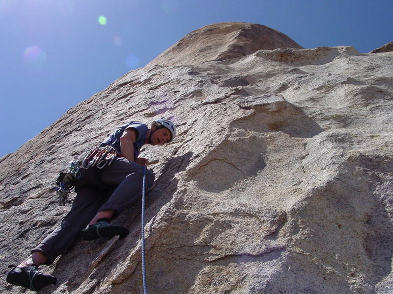 Ivan starting the 9/10a second pitch. The first bolt can be seen way up above his head to the right of the second tiny corner facing right. A couple of slings over flakes psychologically protect the upper run out to the corner system above.