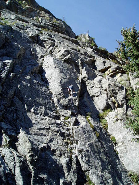 Starting the first crux section. You tiptoe up and right along a narrow slab with your feet near the arete, and then reach straight left to make the clip. This was the only sporty section on the climb.