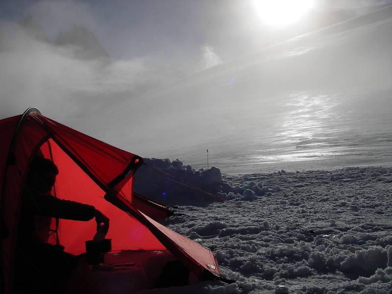 Me melting snow for water during a misty evening on the Upper Tellot. Photo by Tom Gray.