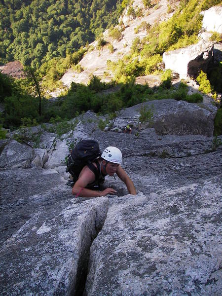 Climbing up the last 5.10a pitch. The Acrophobe's Traverse can be seen in the top right.
