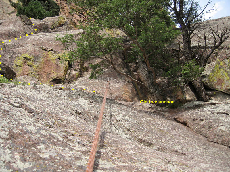 The new bolted rappel anchor at the top of the Upper Ramp. Installed 8/21/06.<br>
<br>
Traverse in from climber's left to avoid using the tree to downclimb.<br>
<br>
The rope pull is clean with little friction. The rope only contacts the rock at the edge of the dropoff (where this photo was taken).<br>
<br>
The old tree anchor is just to the right.