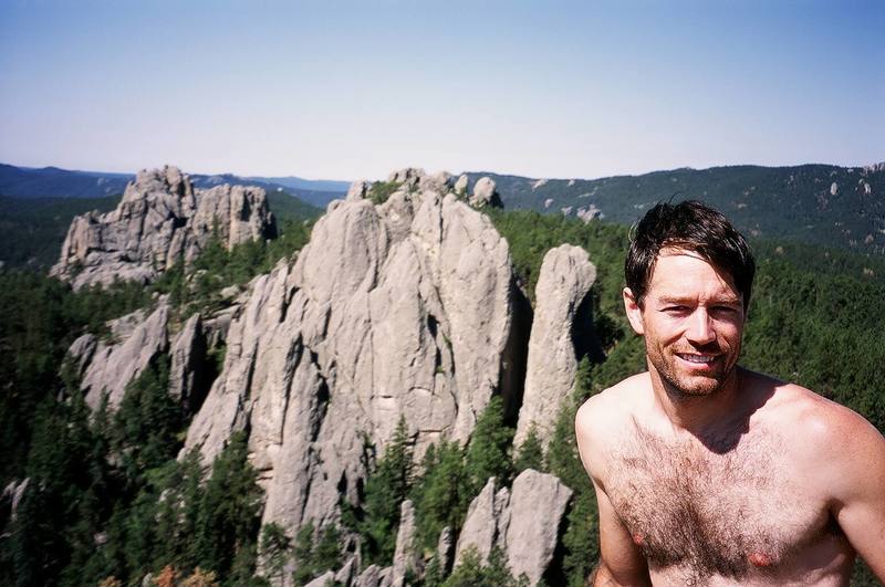 Tony Bubb atop Bell Tower in the Needles of S. Dakota. Photo by Jason Haas, 8/06.
