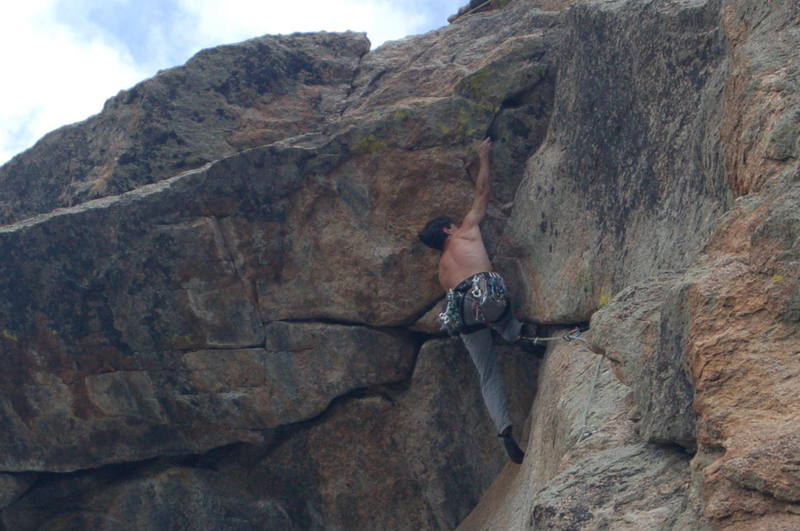 Tony Bubb going horizontal on the crux of Marlin Alley (11b) on Batman Rock at Lumpy Ridge. Photo 9/06.