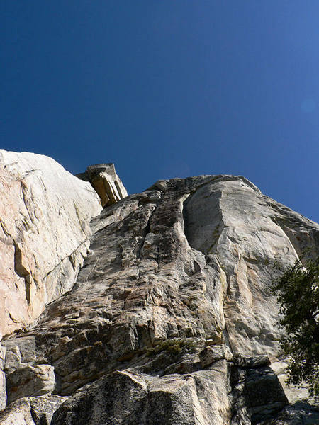The huge dihedral on the left is Open Book, the right leaning layback crack up above is Zig Zag, the juggy chimney and face is Mechanic's Route, and the right smooth dihedral is The Green Arch.