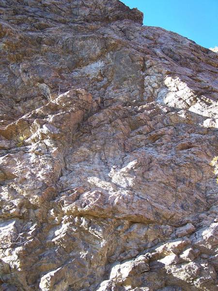 Climb the right-facing dihedral and then climb through the headwall in the right crack.