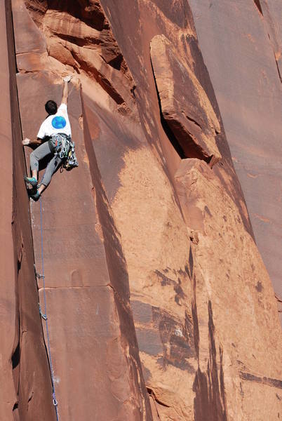 Did someone say 'Ape Index?'<br>
Tony Bubb just above the crux on The Reaper Wears Pink (5.11-), on the Original Meat Wall in Indian Creek. Photo by Jason Haas, 10/06.