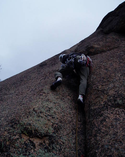Ivan starting up P2. Strange but beautiful light in this photo highlights the crystalline granite. This easy start is followed by a lot of deceptively difficult wider crack climbing.
