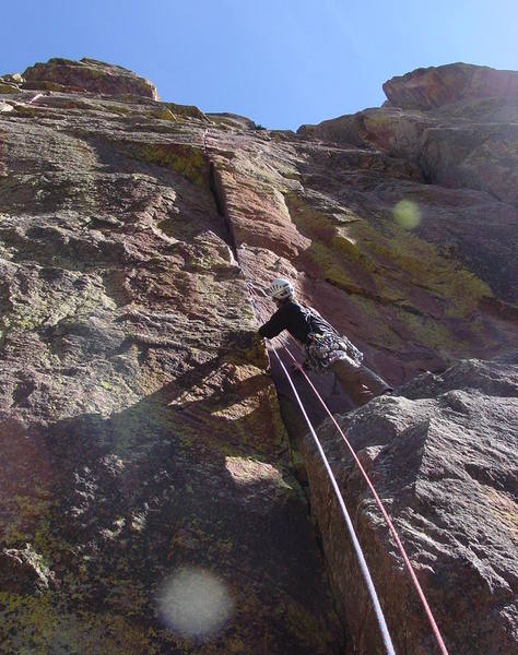 Peering up at the first hard moves. Fingertip laybacks lead to a great fingerlock, but it continues hard until you're situated in the left-facing corner.<br>
<br>
Photo by Paul Rezucha.