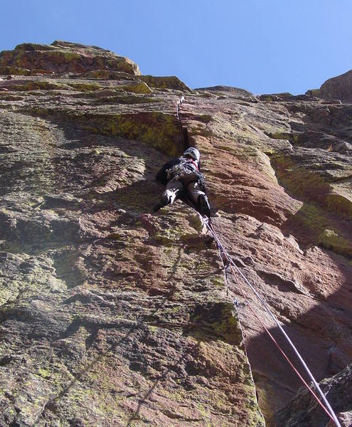 Placing gear at the base of the wide crack. A #4 Camalot is a little small at first, but you can push it up into a better spot as you thrutch your way up.<br>
<br>
Photo by Paul Rezucha.