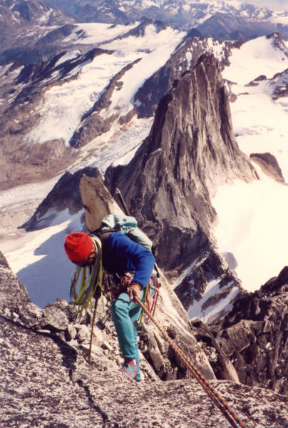 Tony Tennessee rappels towards the Gendarme on the Kain Route during the descent. Snowpatch Spire behind.