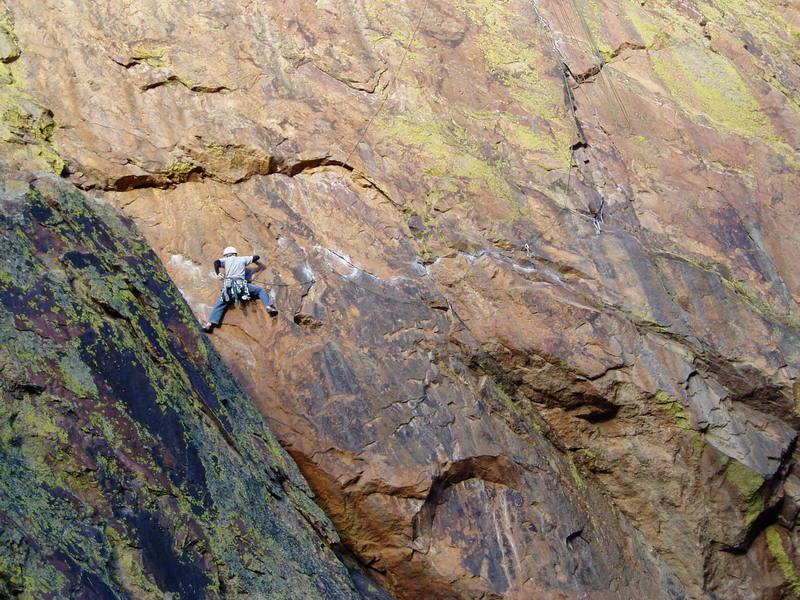 Unknown climber following P1 after unclipping the first bolt. The leader trailed a rope which is used to good effect protecting the second from taking a big swing.