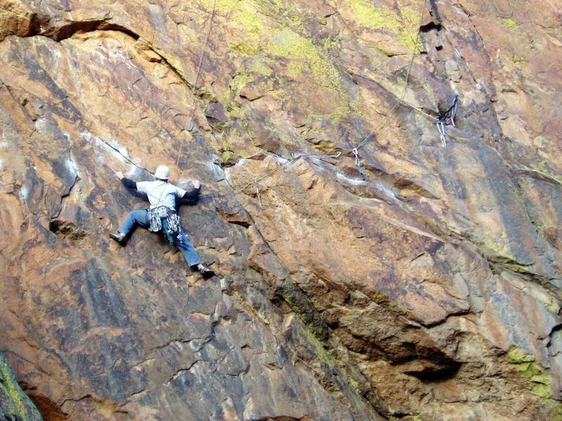 Unknown climber following the downward crux moves beyond the second bolt.