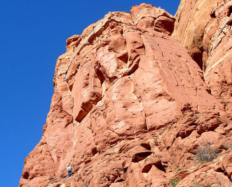 Jake styles Bootle Call 10d, a long route on sunny rock.