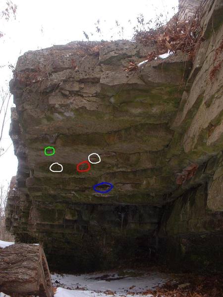 The red circle indicates where the crimp broke. <br>
The blue circle is the big jug and the green circle is the pocket.<br>
Mike Taylor and I have tried going from the ledge/jug straight to the pocket. This is a horrendously big move. If someone ever gets this it will be BIG! What I think what is end up happening is having to make "detour" and going to either one of the white circles. Good luck!