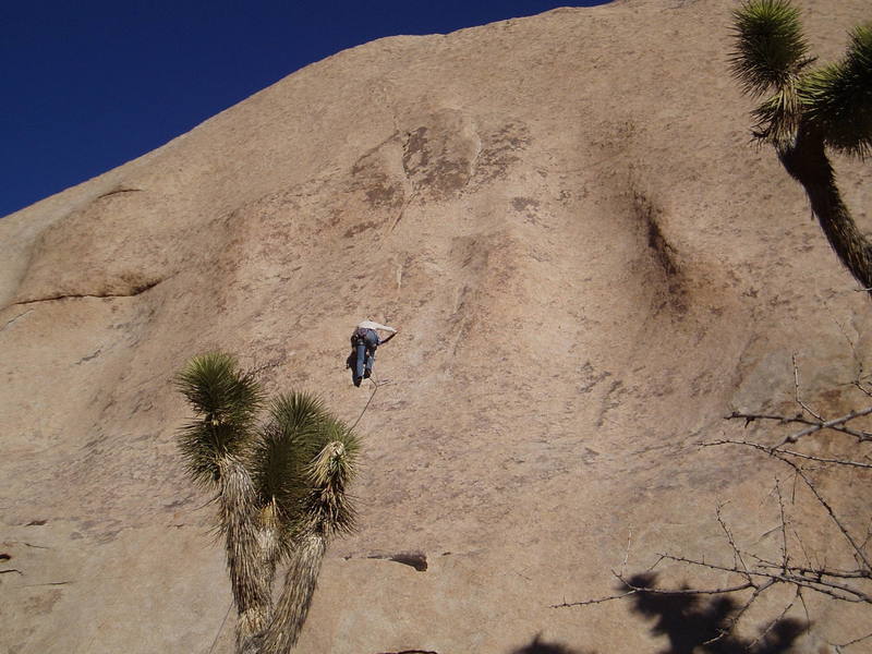 Kris moving through the crux on a cool windy day.