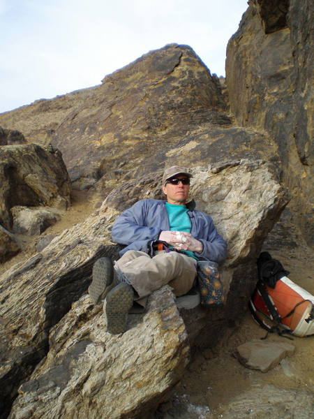Relaxing at the base of Hueco Wall. Nice seat!