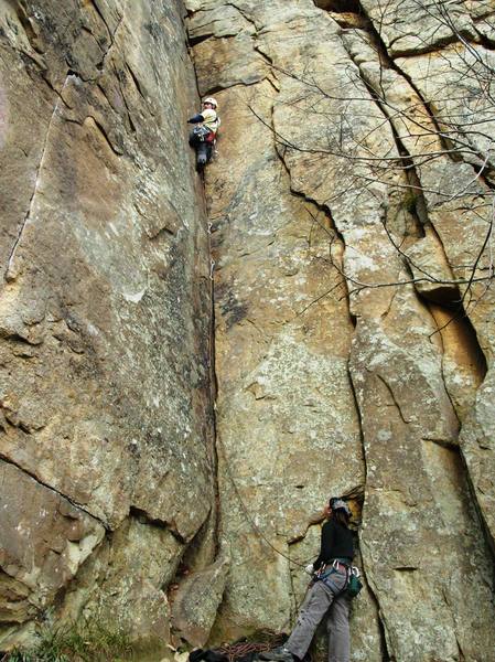 JenT looks on as I take a rest with my leg firmly planted in one of the Jay Walker cracks. This picture also shows a taste of the 5.10 crack on the left and the 5.8 flake on the right.
