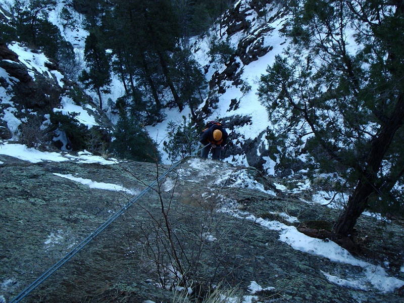 Rappelling from the prominent shelf at the base of the climb.