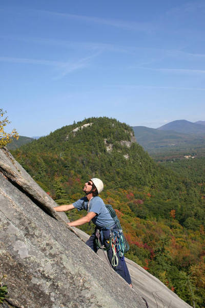 My dad (Ernie Hansche) on sliding board (5.7) with Cathedral Ledge in the background...