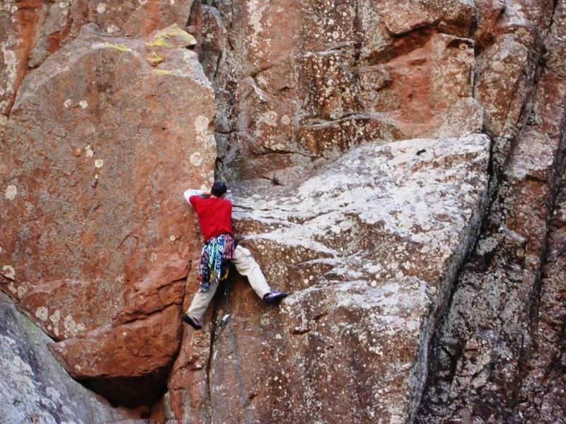 Daniel diverging off of the Ker Plunk ramp onto Monkeys Way (Crux). A small cam protects the 5.7 move well.
