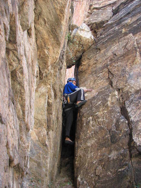 Bouldering up the short chimney to get to the start of "Rosie."