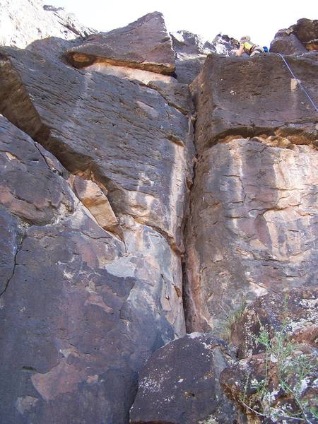 Climb in the corner and then up the arete to the anchors. There is an unidentified climber to the right on a 5.8. that I didn't bother climbing.