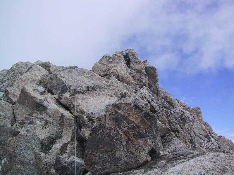 The final pitch above the Petzoldt Lieback, Warren is climbing the "small 10' tower". The summit is only a few minutes away.